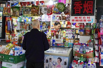 Strolling in Chongqing, Chongqing Province, China, Asia, A customer looks at a selection of food