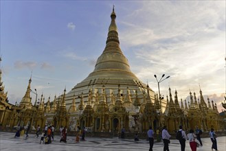 Shwedagon Pagoda, Yangon, Myanmar, Asia, People visit the golden Shwedagon stupa at dusk, Asia
