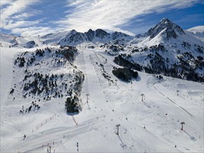 Snow-covered slopes with skiers and lifts in the sunny mountain area, Grau Roig, Encamp, Andorra,