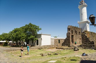 COLONIA DEL SACRAMENTO, URUGUAY, Dezember 30, 2023:Tourists photographing the Lighthouse in the