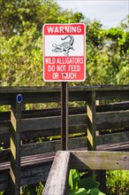 Alligator warning sign, Miccosukee Tribe Island, US Highway 41, Miami, Everglades, Florida, USA,