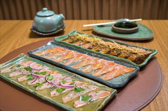 Delicious premium salmon sashimi arranged on an elegant handmade platter