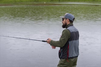 Black bass fisherman fishing inside lake, Cambara do sul, Rio Grande do sul, Brazil, South America