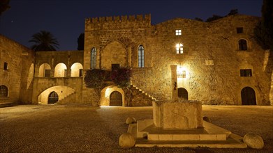 Night view of an illuminated historical castle with a fountain in the foreground, night shot, Old