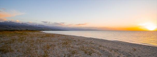 Shore with sandy beach, Issyk Kul Lake at sunset, Issyk Kul, Kyrgyzstan, Asia