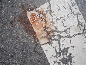 Handprint on a zebra crossing, after removal of a climate sticker, Leoben, Styria, Austria, Europe