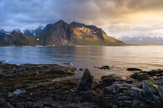 Landscape with sea and mountains on the Lofoten Islands, view across the fjord to the small town of