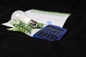 Light bulb on a stack of cash, symbolizing a bright financial idea