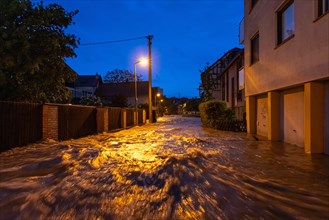 After heavy rainfall, the centre of the Frankfurt district of Niederursel is under water,
