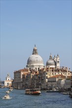 Water taxis, and vaporetto with Renaissance architectural style palace buildings and Santa Maria