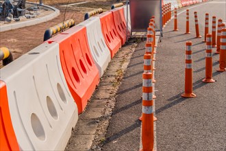 Traffic bollards and plastic barriers around sign at edge of road in South Korea