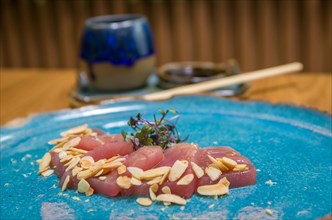 Delicious premium tuna sashimi arranged on an elegant handmade platter