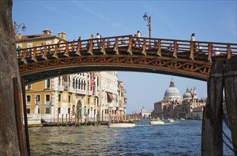 Accademia footbridge over Grand Canal with water taxis, Renaissance architectural style residential