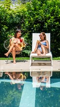 Friends relaxing by the pool at a luxury hotel