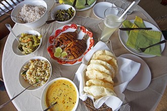 Traditional Kerala dishes, striped cichlid in the centre, Kerala, India, Asia