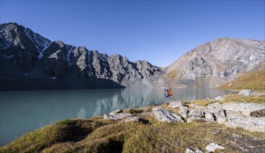 Mountaineers at the turquoise Ala Kul mountain lake, Tien Shan Mountains, Kyrgyzstan, Asia