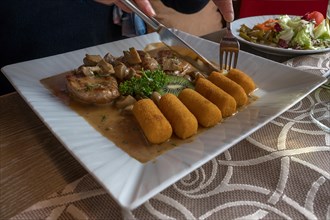 Steak with Common mushroom and croquettes served in a Gatshaus, Franconia, Bavaria, Germany, Europe