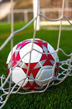 Close up of soccer ball inside the net field. Soccer ball inside the goal field. Football fever