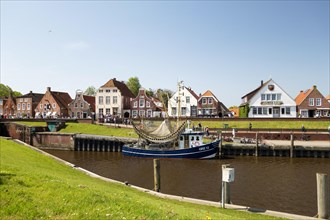 Picturesque cutter harbour, Greetsiel, ebikes, gabled houses, Krummhoern, East Frisia, Germany,
