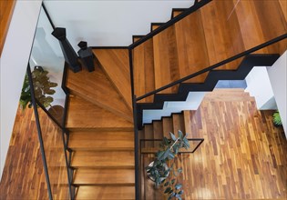 Top view of black powder coated steel L-shaped staircase with stained and varnished wooden steps