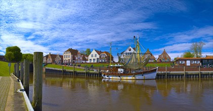 Fishing boat and historic houses at Greetsiel harbour, panoramic photo, Greetsiel, Krummhoern, East