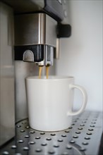 Closeup of espresso pouring from coffee machine