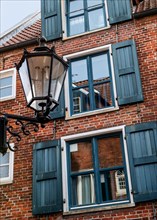 Detail of alleyway lamp and house facade on the Wilhelminengang alley in the historic old town,