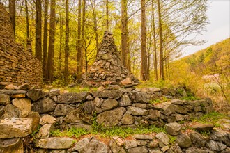 Stone cone shaped tower in small tree lined park near Sejeonggol, South Korea, Asia