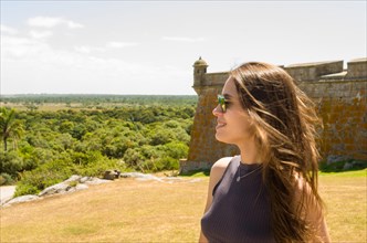 Young woman looking at Forte de Santa Tereza in Uruguay, important tourist site
