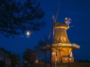 The Green Mill, one of Greetsiel's twin mills, at full moon, Greetsiel, Krummhoern, East Frisia,