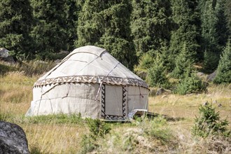 Yurt in front of a forest, Kyrgyzstan, Asia