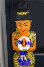 Figure with wreath of flowers at the entrance to the Thai massage parlour, Kaufbeuern, Allgaeu,