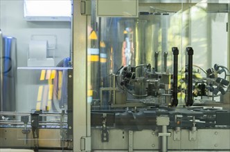 Wine production machine, filling the bottles. Industrial production