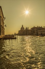 Silhouetted view of Grand canal with water taxis and Santa Maria della Salute basilica in