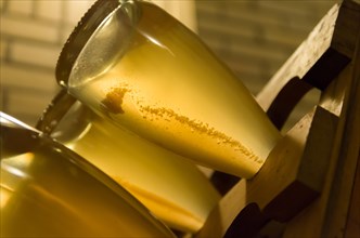 Bottles in the pupitres for the yeasts to accumulate in the neck of the bottle