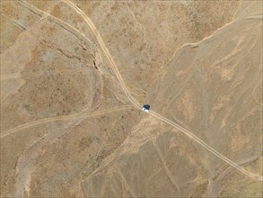 Aerial view, Vast empty landscape, Road and off-road vehicle, Top down view, Two paths divide,