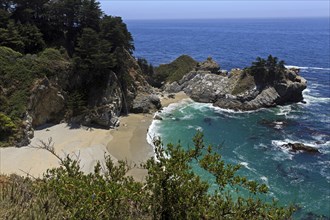 A waterfall pours into the sea on a sandy beach, Big Sur Pfeiffer, US 1, North America, USA,