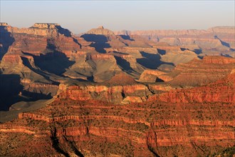 The sun bathes the Grand Canyon in a warm, orange-red light, Grand Canyon National Park, South Rim,