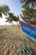 Colourful fishing boat at Marari Beach or beach, Mararikulam, Alappuzha district, Kerala, India,