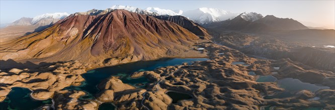 Aerial view, high mountain landscape with glacial moraines and mountain lakes, behind Pik Lenin,
