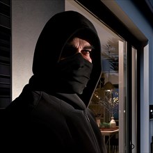 Close-up of a burglar with covered face at night in front of a window, burglary, burglar, burglary,