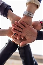 Low angle of group of people bumping fists. Togetherness and togetherness concept