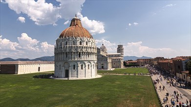 A sunny view of Piazza dei Miracoli in Pisa with the Battistero and the Cathedral of Santa Maria