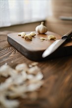 Peeled garlic on a chopping board