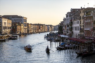 View over the Grand Canal with water taxi and gondolier in the evening light, from the Rialto