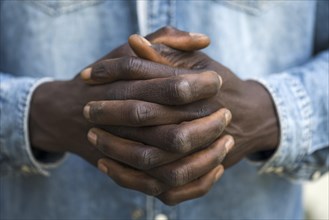 Folded hands of an African migrant, Bavaria, Germany, Europe