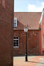 Detail of street lantern and clinker facades on Neue Strasse, City of Leer, East Frisia, Lower