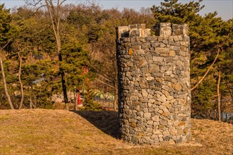 Stone structure resembling castle towers at public mountain park on sunny day in Yesan, South