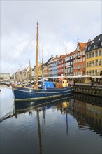 Moored sailboats and colourful 17th century apartment buildings and houses along the Nyhavn canal,