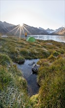 Hiker, camping in the wilderness, mountain lake in the Tien Shan, Lake Ala-Kul, Kyrgyzstan, Asia